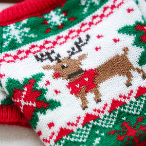 Close-up of a knitted fabric with Christmas reindeer pattern