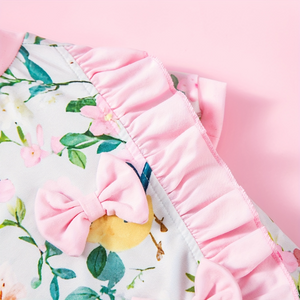 Close-up of a floral fabric with pink ruffled trim
