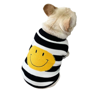 Featuring black and white horizontal stripes and a large yellow happy face, this dog sweater is perfect for small to medium dogs.