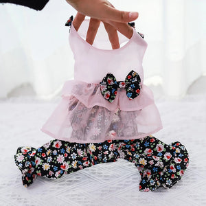Pink top with floral pants on a white surface