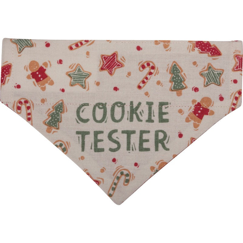Christmas Reversible Dog Bandana has "Cookie Tester" sentiment with cookie designs on one side on a cream background, and "Santa's Favorite Wigglebutt" sentiment with paw print designs on a red background on the other