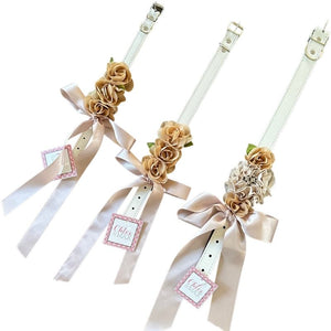 Perfect for weddings, these stunning handmade beige silk flowers on a faux white leather collar feature a matching beige satin bow