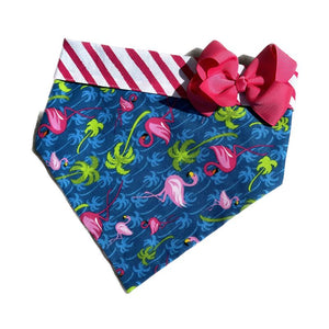 Handmade in the USA, this Blue Flamingle Bandana Collar with Bow has pink-and-white striped trim and backing.