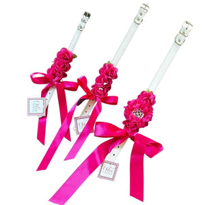 Perfect for weddings, these stunning bright pink silk flowers on a faux white leather collar feature a matching pink satin bow.