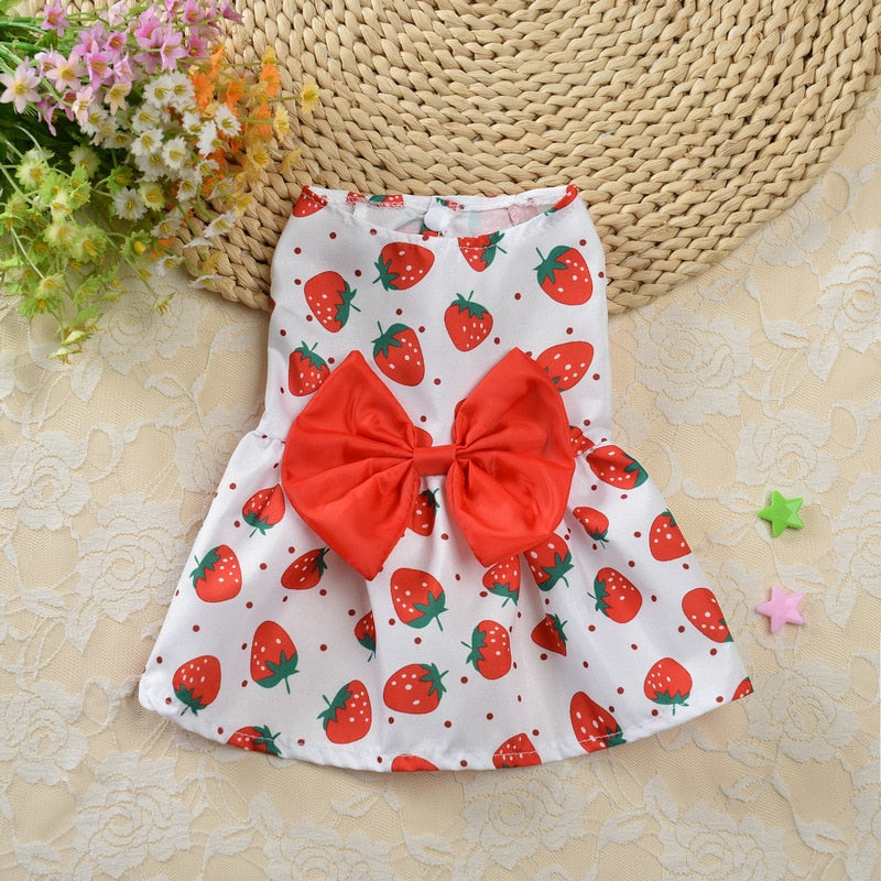 White dress with red strawberries pattern and big red bow