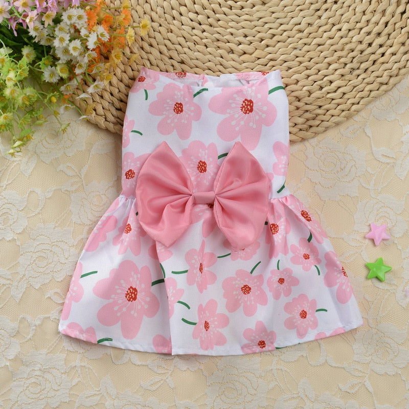 Adorned with a pink bow, this lightweight cotton Pink Flower Dog Dress from our Spring/Summer collection fits small dogs