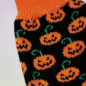 Halloween Pumpkin Dog Sweater shows rows of smiling jack-o-lanterns.