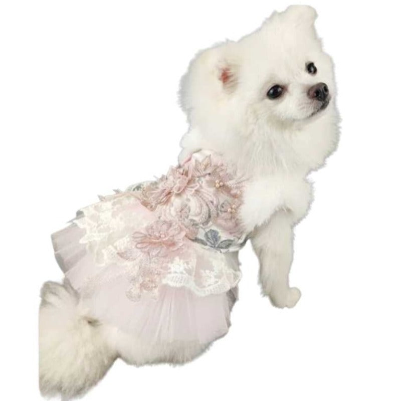 Designed for Posh Dog Life, our handmade Juliette Dog Party Dress is exquisitely crafted for your winter princess with the finest details, including fur, feathers, flowers, faux pearls, embroidered floral lace and a tulle skirt.