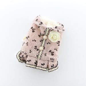 Available in pink, this elegant dog dress is adorned with a bow pattern, faux pearl buttons and rose flower brooche.