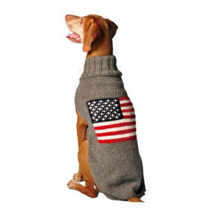 Dog wearing a sweater with an American flag design on a white background