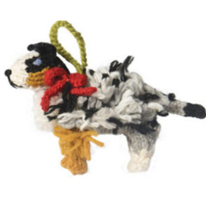 Knitted dAustralian Shepherd ornament with red bow on a white background