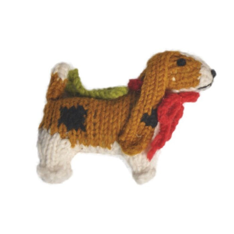 Basset hound knitted ornment with a red scarf on a white background