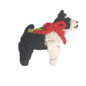 Knitted Boston Terrier ornament with a red bow tie on a white background