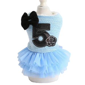 Light blue pet dress with number 5 and black bow on a mannequin against a white background