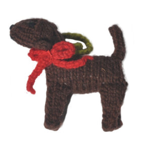 Knitted dog toy with a red bow on a white background