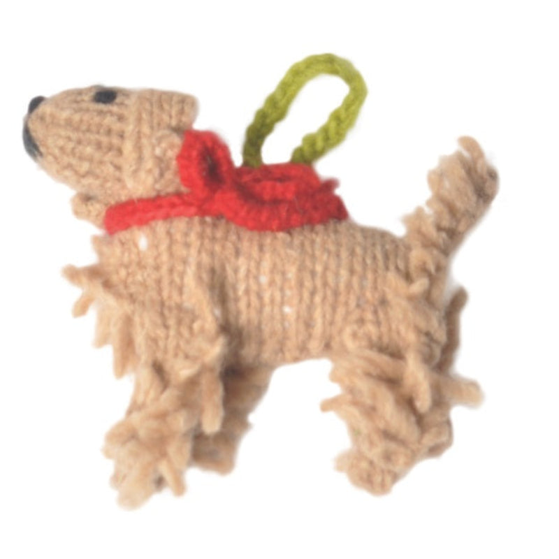 Knitted Cocker Spaniel dog ornament with a red bow on a white background