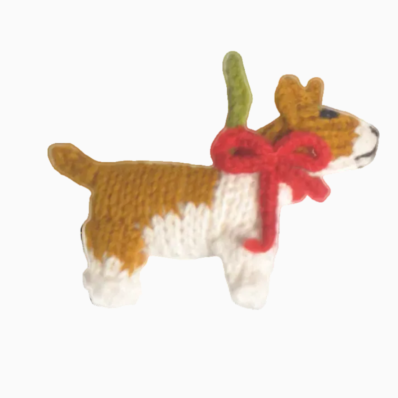 Knitted dog toy with a red bow on a white background