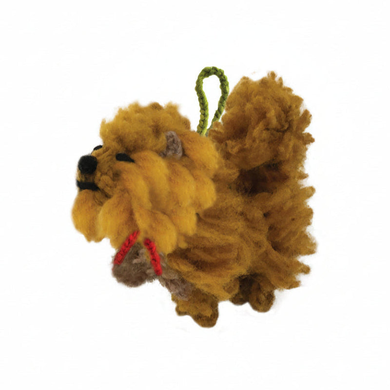 Chow chow dog ornament with red bow on white background.