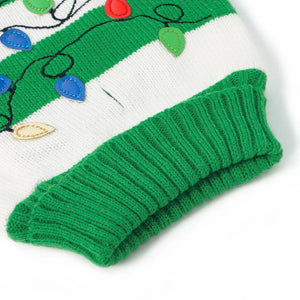 Green and white knitted dog sweater with Christmas lights design on a white background