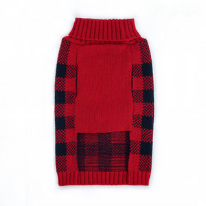 Underside of red and black plaid dog sweater on a white background