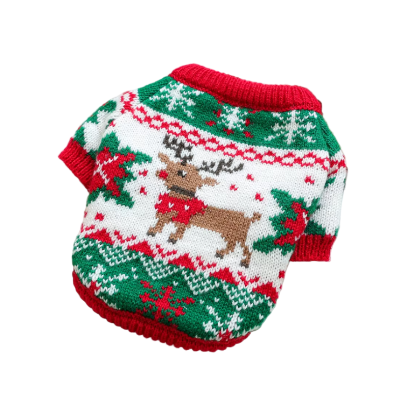 Christmas-themed dog sweater with reindeer design on a white surface with decorative items.