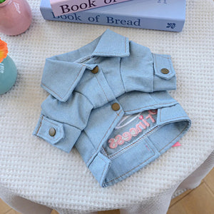 Light blue denim jacket has 3 snap buttons on underside
