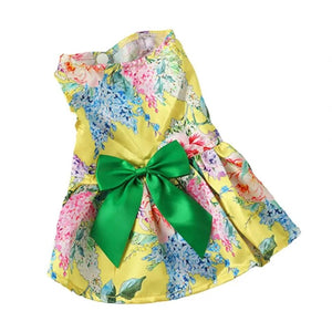 Yellow floral dog party dress features a green bow