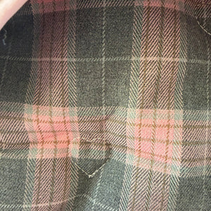 Close-up of pink and gray plaid fabric with a focus on texture and pattern. Has heart embrodiery