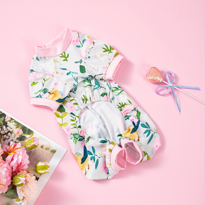 Floral dog outfit with pink accents on a pink background