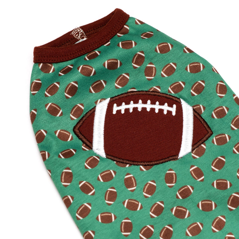 Dog shirt with football pattern on a green background