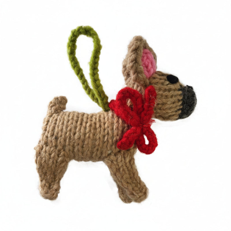 Knitted French Bulldog dog ornament with a red bow and green handle on a white background
