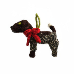 Knitted German Shorthaired Pointer ornament with a red bow on a white background