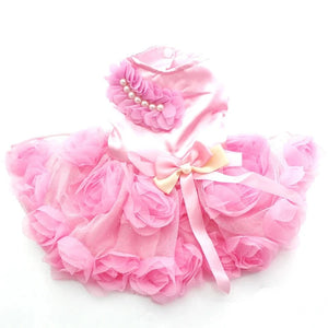 Toy Poodle wearing Elegant Roses Dog Party Dress in pink. has pearl beading across one shoulder