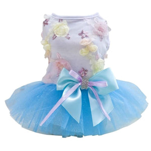 Blue Garden Party Dog Dress is adorned with flowers, waistline bow and tulle skirt.