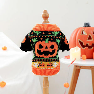 Halloween-themed dog sweater on a mannequin with pumpkins and candles in the background.