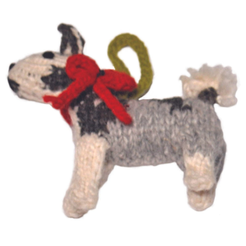 Knitted husky ornament with a red bow on a white background
