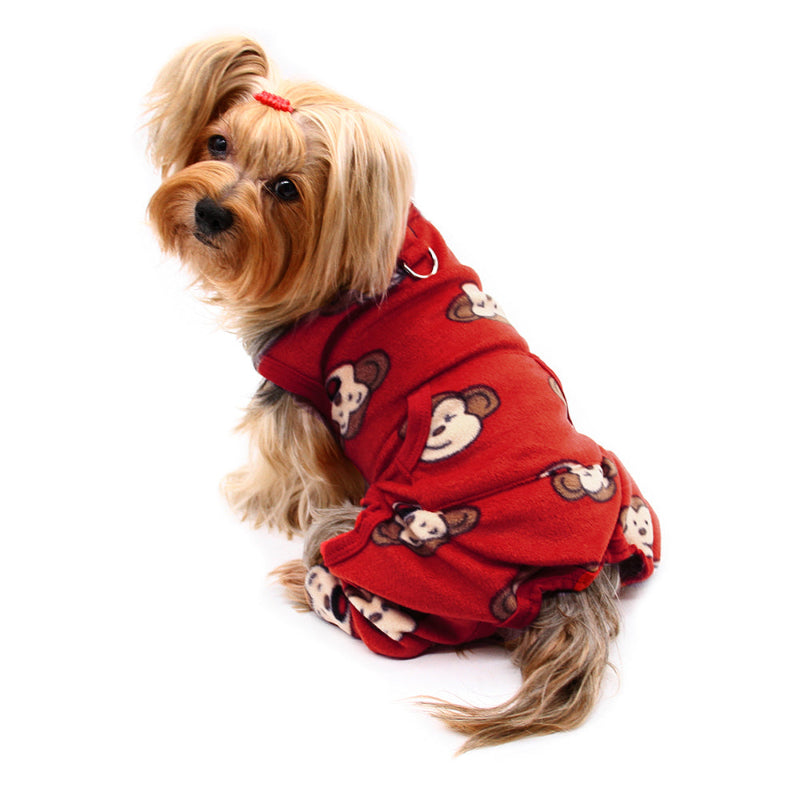 Small dog in burgundy fleece pjs with monkey pattern