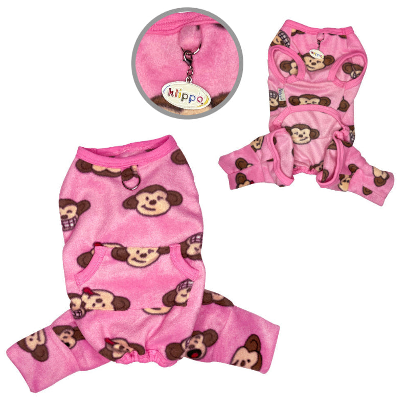 Dog wearing a pink fleece pajamas with monkey patterns 
