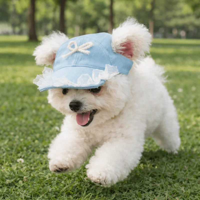 Light blue cap with white lace and bow on a wooden surface