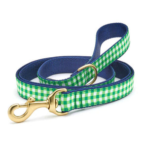 Dog leash with green and white checkered pattern and gold clasp on a white background