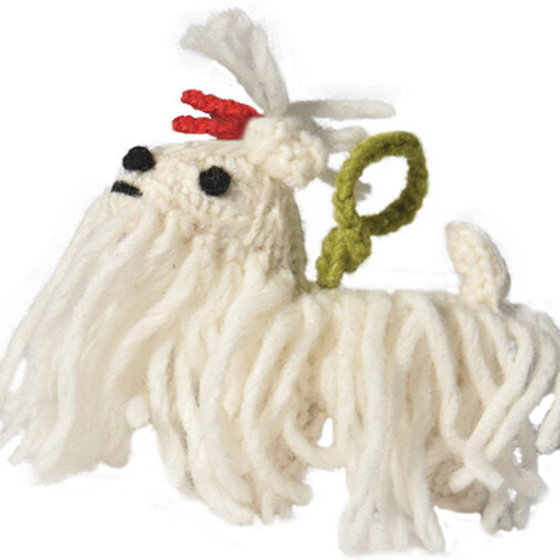 White yarn dog ornament with red bow on a white background