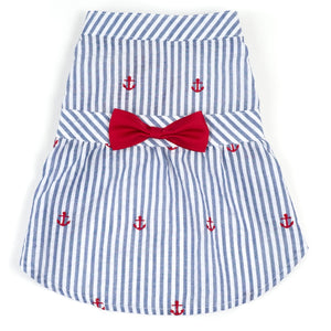 Blue and white striped dress with red anchors and a bow on a white background