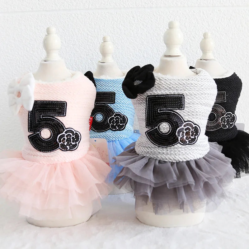 Dog dresses with number 5 design on mannequins against a white background