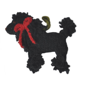 Black poodle with a red bow on a white background