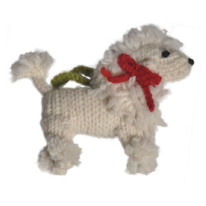 A small knitted Poodle dog ornament or plush figure made from off-white yarn, with a red bow around its neck and a green hanging loop, shown on a plain white background.