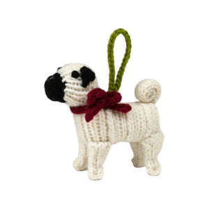 Crocheted dog ornament with a red bow tie on a white background