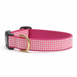 Pink gingham dog collar with a black buckle on a white background