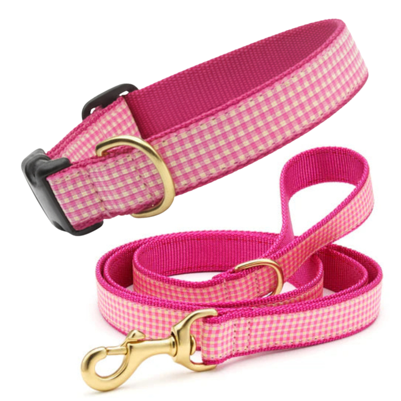 Pink gingham dog collar and leash set on a white background