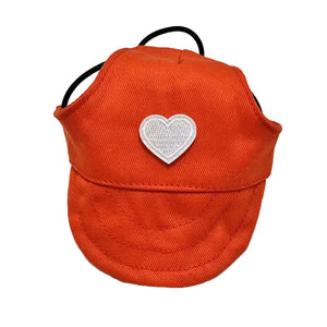 Red cap with a white heart patch on a white background