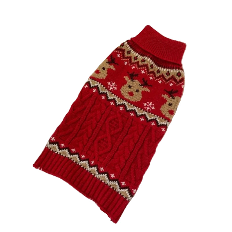 Red knitted dog sweater with reindeer pattern on a textured surface